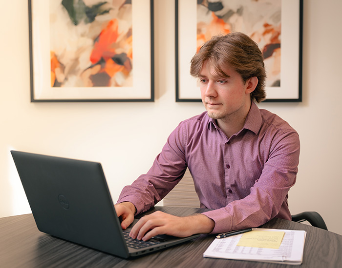 Umbreit, Wileczek & Associates account working on laptop