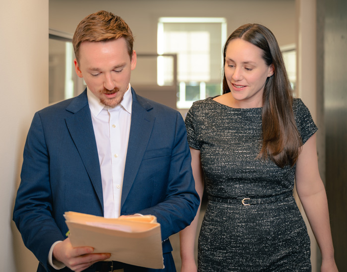 Umbreit, Wileczek & Associates accountants reviewing files while walking through the office