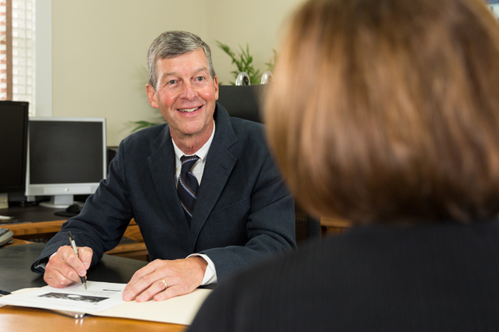 Man writes in a file while speaking with a client